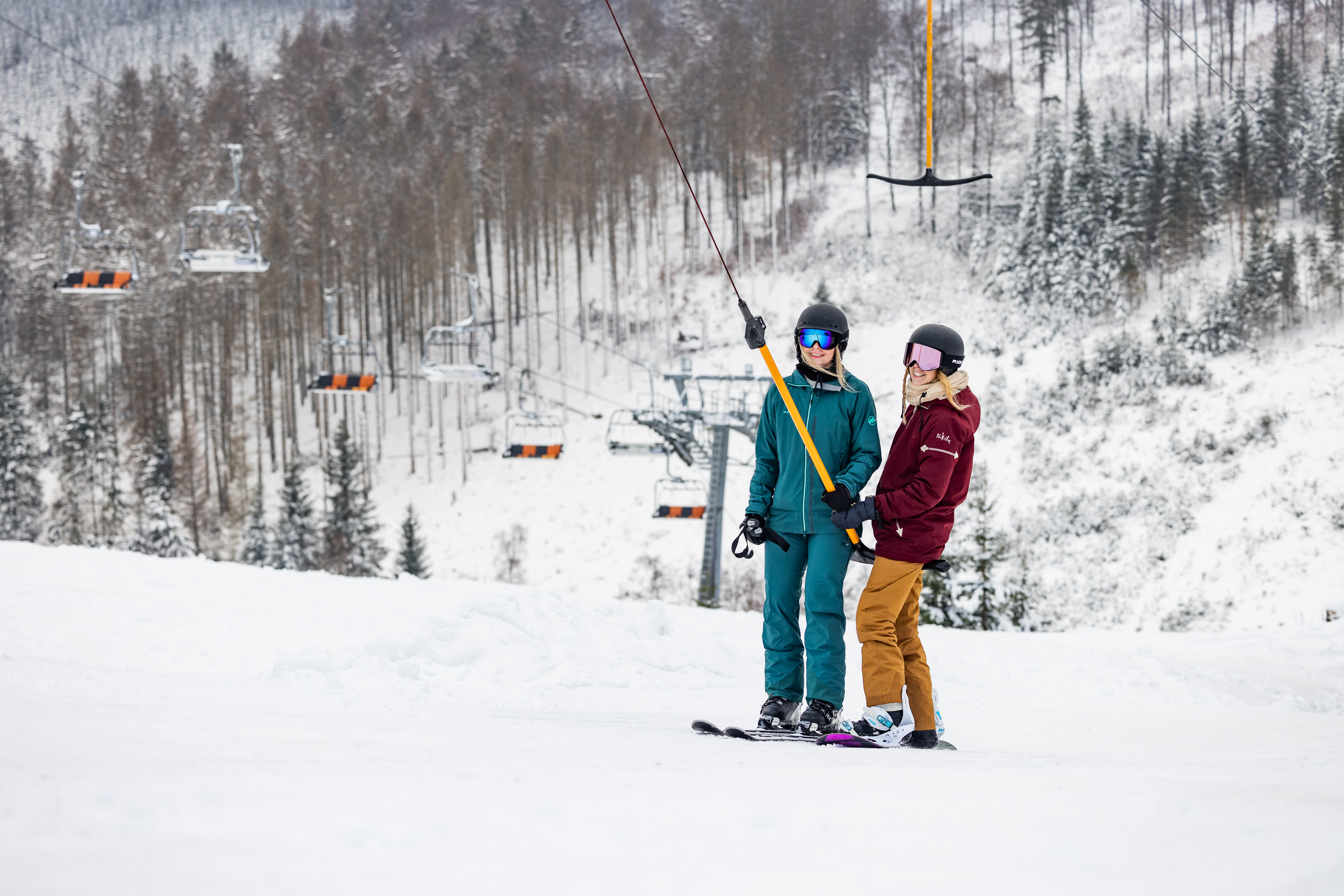 Zwei Personen an einem Ankerlift.