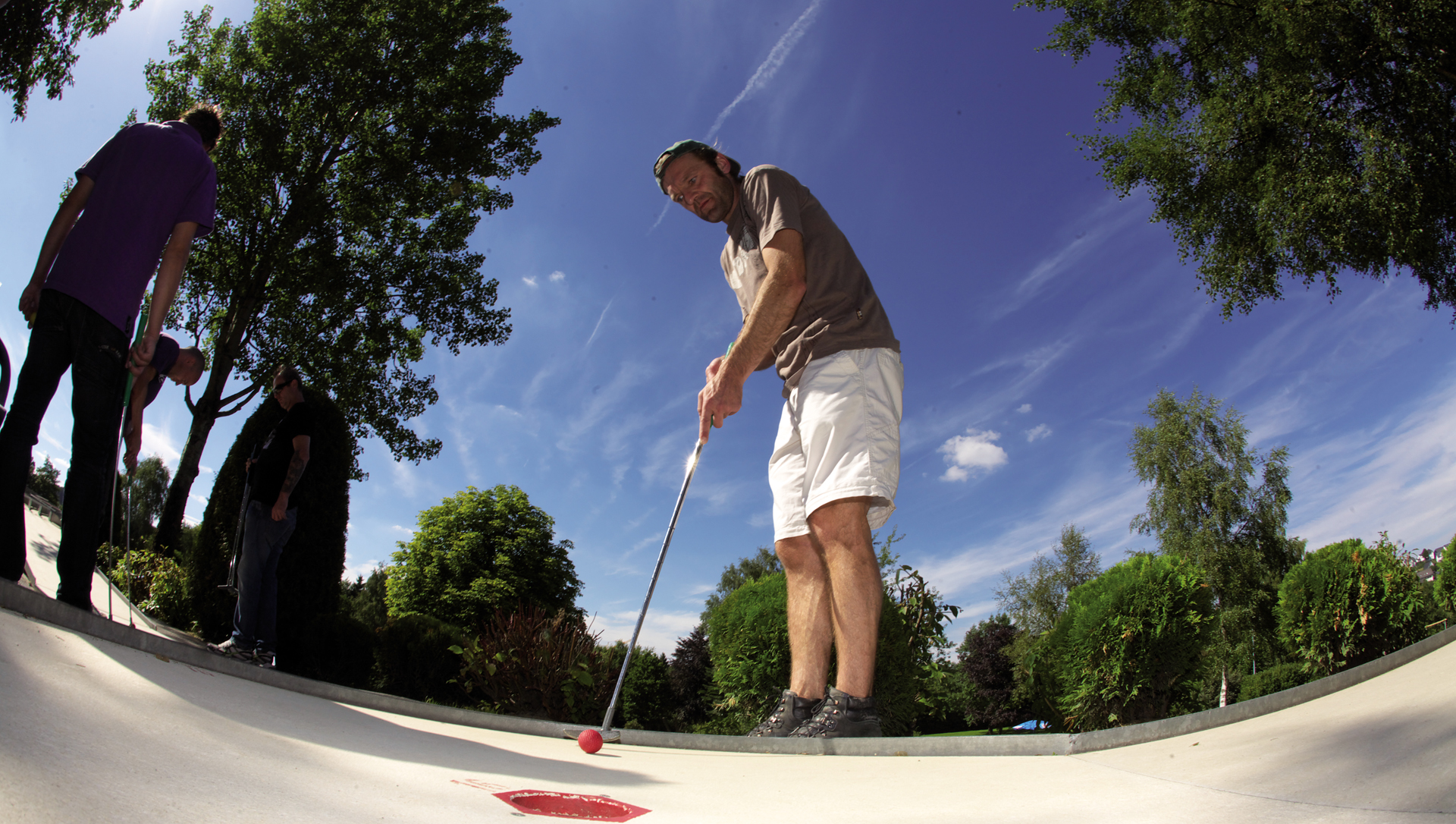 Ein Mann beim Minigolf spielen. Ein Mann beim Minigolf spielen.